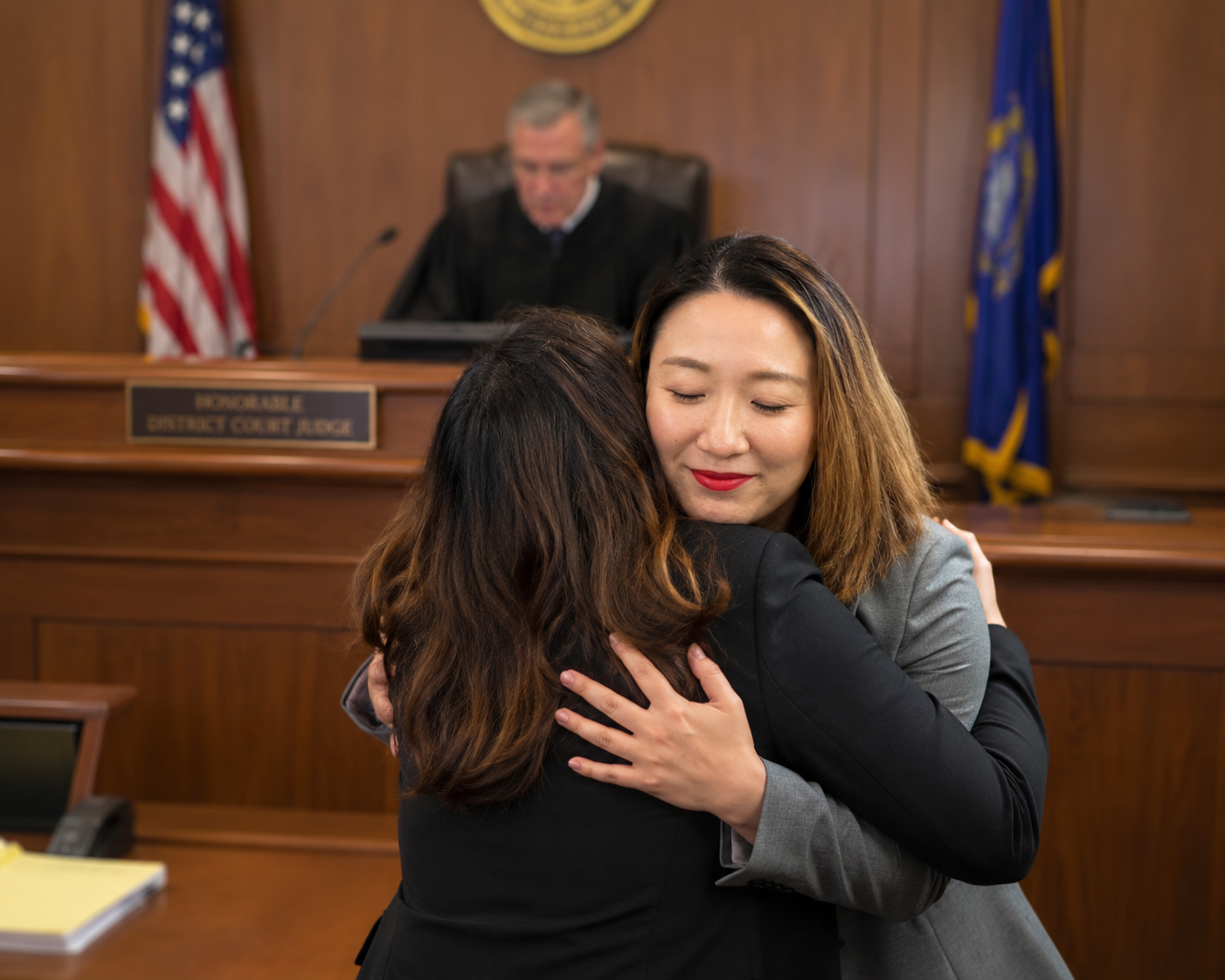 Summer Squires hugging a prevailing client.